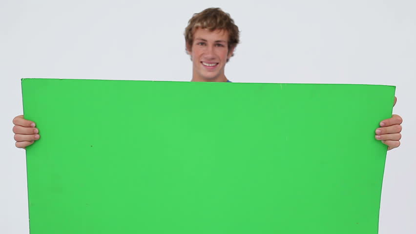 Cheerful man holding a blank poster against a white background