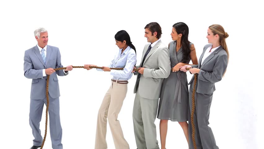 Business team playing Tug-of-War against their boss against a white background