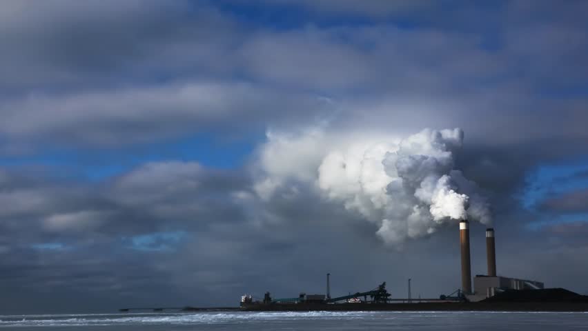 A coal fired power plant spews out smoke - time lapse