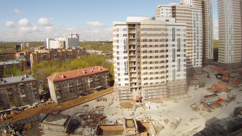 Old house stands near under construction new houses on Apr 30, 2012 in Moscow, Russia
