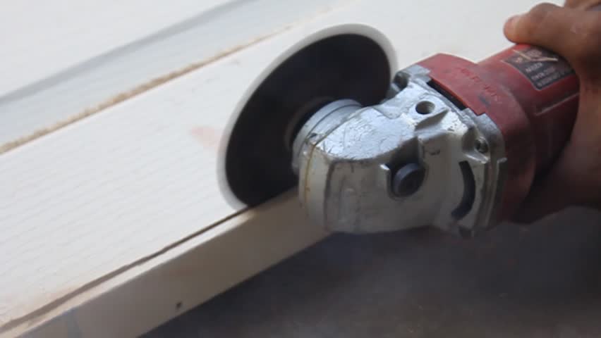 Carpentry cutting wood with an electrical saw.
