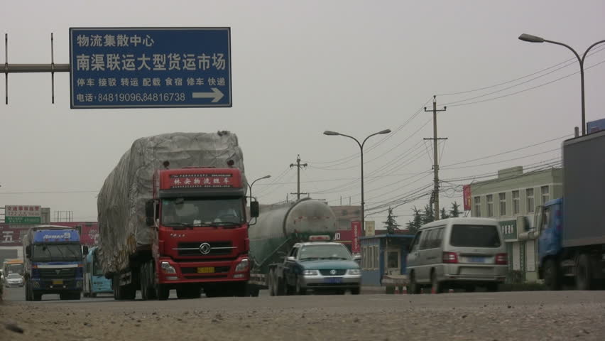 QINGDAO - JUNE 11: Heavy transport drives over a provincial road in the suburbs on June 11, 2010 Qingdao, China