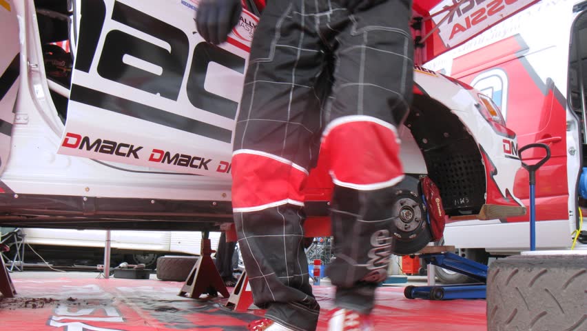 MOSCOW - APR 21: (Timelapse View) Mechanic establishes forward wheel on car of team ALM RUSSIA before start, on Rally Masters Show, on April 29, 2012 in Moscow, Russia