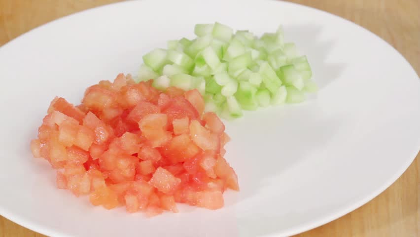 Chopped tomato, cucumber and pepper on a plate