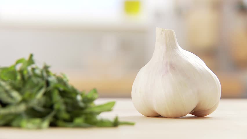 Garlic being peeled and halved