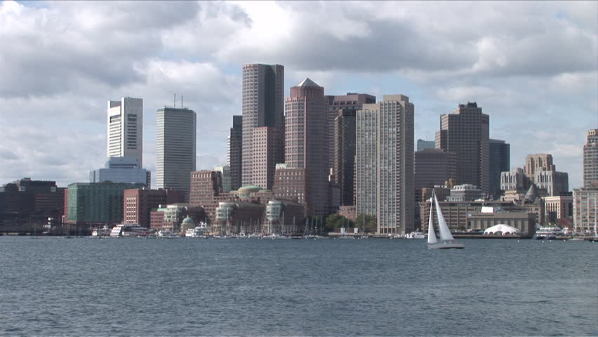 View of the skyline of Boston with boats in the water 