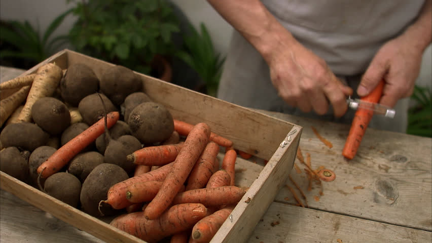 Man peeling a carrot