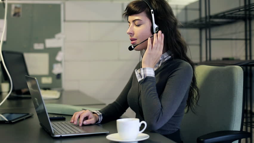 Friendly happy female helpdesk consultant in the office
