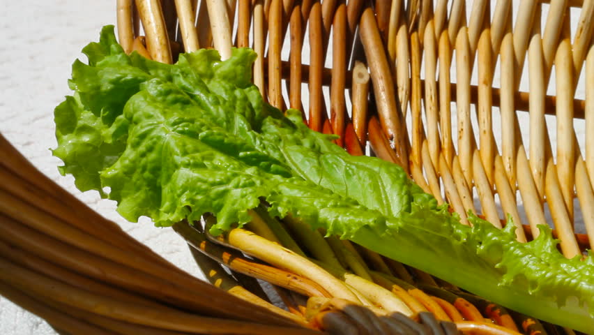 	Salad and green onions in a basket.
