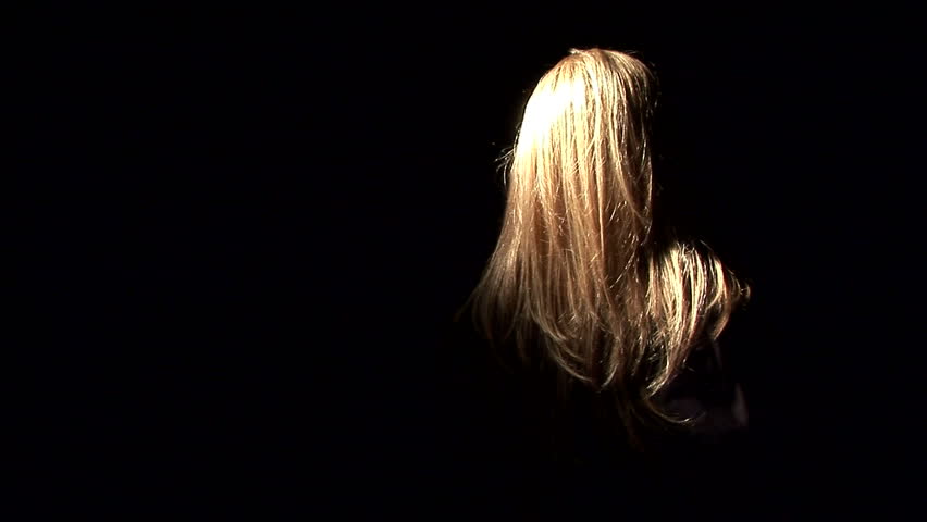 A ghostly, masked figure with long blond hair and a kitchen knife.