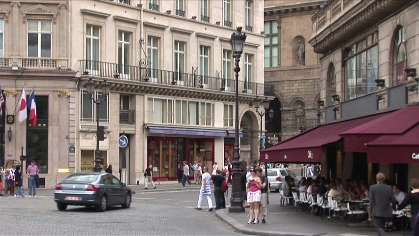 Paris, France - CIRCA June, 2006: A typical Parisian street scene with old buildings and young people