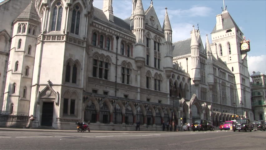 London, England - CIRCA June, 2006: A wide shot of the Royal Courts of Justice, with lots of traffic passing by during the day