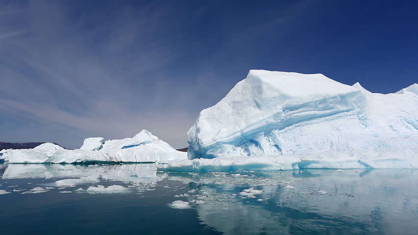 Drifting by an iceberg floating in Qooroq Icefjord, South Greenland