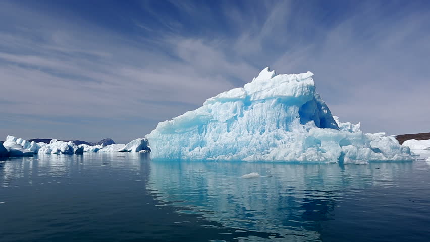 Drifting by an iceberg floating in Qooroq Icefjord, South Greenland