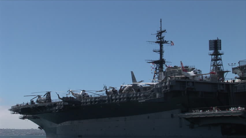 San Diego, CA - CIRCA June, 2008: View of different types of Navy aircraft on deck of the aircraft carrier docked in the bay on a sunny day