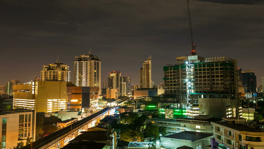 BANGKOK - JULY 14: Time Lapse view of Bangkok city, Thailand at Sunrise on July 14, 2012. Activity seen on contraction site, Aerial subway and cloudscape. Scene shot over a 5:30 hrs period.