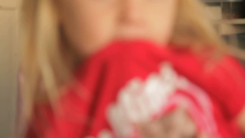 Little girl in preschool chewing on her shirt