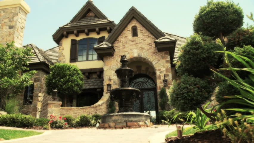 flagstone home with driveway fountain