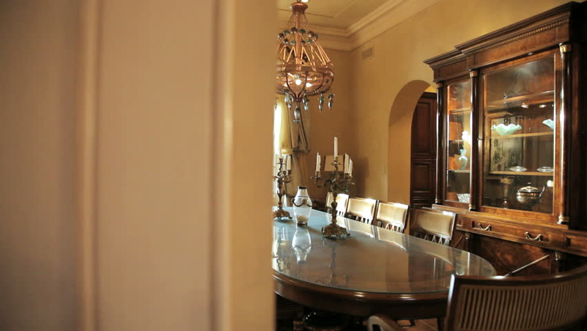 Panning shot of the formal dining area in an expensive home
