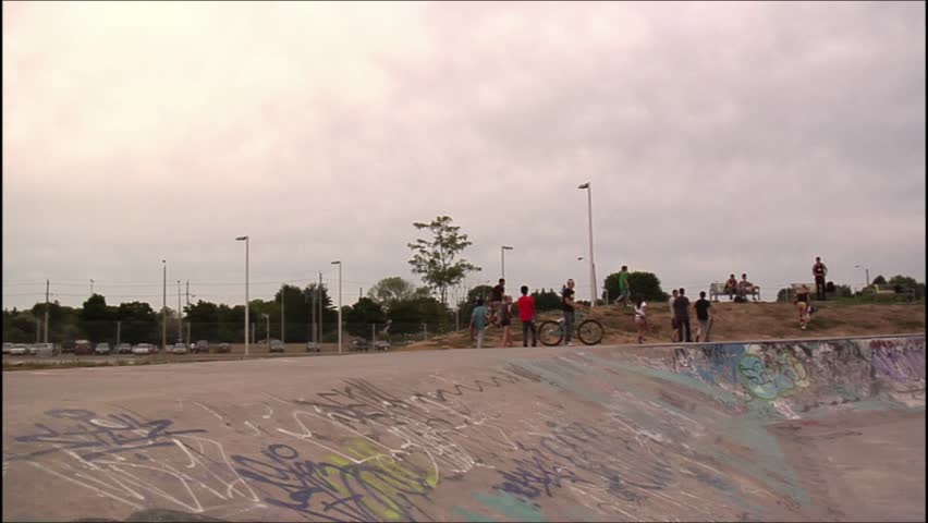 BMXer does a frontflip out of a skatepark