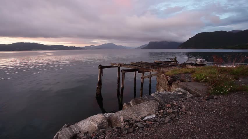 Majestic mountains landscape, fjord in Norway with old wooden pier
