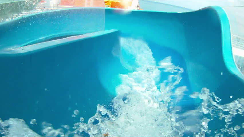 Rider's perspective of sliding down a windy water slide on a cruise ship.