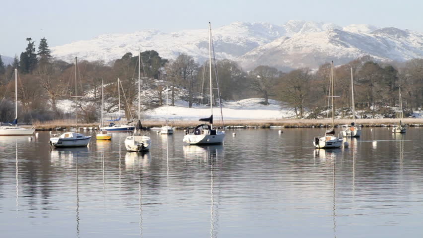 WATERHEAD, CUMBRIA/ENGLAND - JANUARY 7: Pleasure yachts in Winter on Lake Windermere on January 7, 2012 in Waterhead. Lake Windermere is the largest natural lake in England.