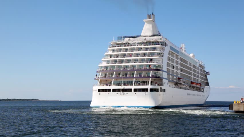 big passenger liner departures from mooring in sea