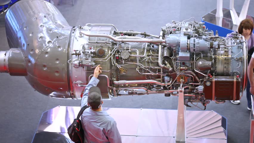 MOSCOW - MAY 21:Visitors look at helicopter engine at exhibition of helicopter industry of Helirussia in Exhibition center Expo Crocus, on May 21, 2012 in Moscow, Russia