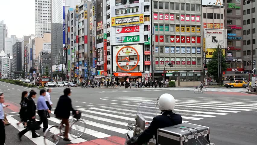 TOKYO - MAY 8: Commuters hurry on May 8, 2012 in Shinjuku district, Tokyo. Shinjuku is one of the busiest districts of Tokyo, with many international corporate headquarters located here.