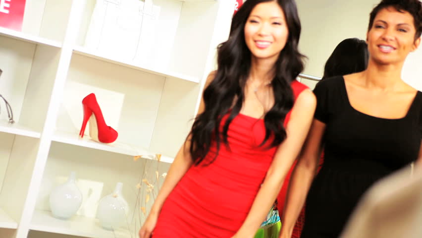 Girls shopping bags browsing elegant boutique