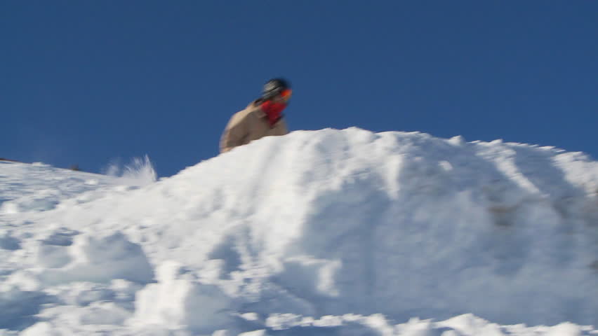 SLOW MOTION - Male skier back flips off jump