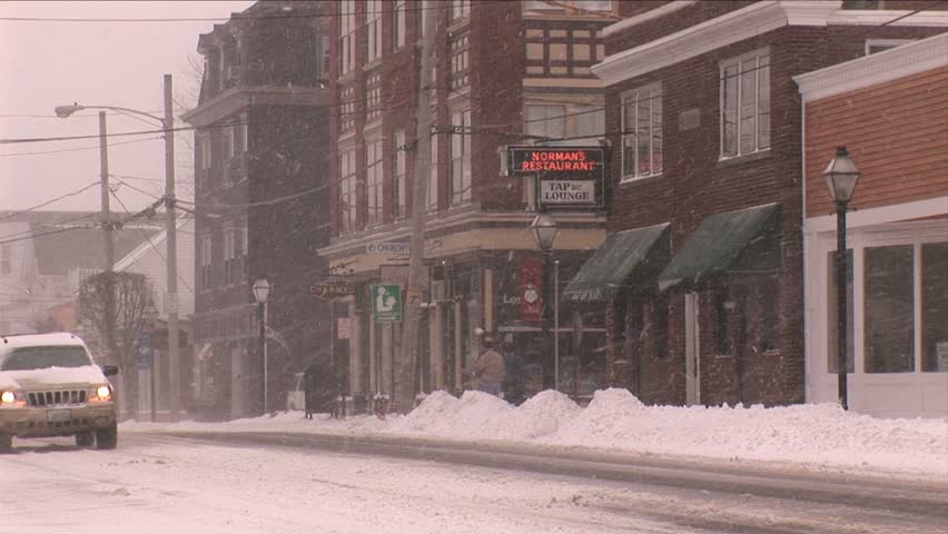 NEW ENGLAND - CIRCA JANUARY 2006: Snow falling on small town business area and street
