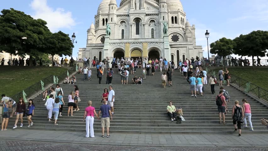 PARIS - CIRCA JULY 2012: People congregate on the steps in front of the Facade of the Sacre-Coeur Basilica in Paris circa July 2012 in Paris, France.