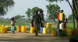 BOR, SOUTH SUDAN - JUNE 24: Children carry water from a central water point that runs for a few hours a day on June 24, 2012 in Bor, South Sudan. Clean water is a major health issue in Africa