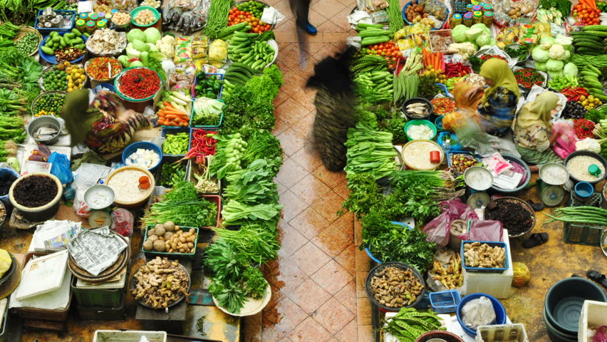 MALAYSIA - JANUARY 24: Time lapse of Muslim woman selling fresh vegetables at the traditional bazaar market Siti Khadijah Kota Bahru on January 24, 2011 in Kelantan, Malaysia. 