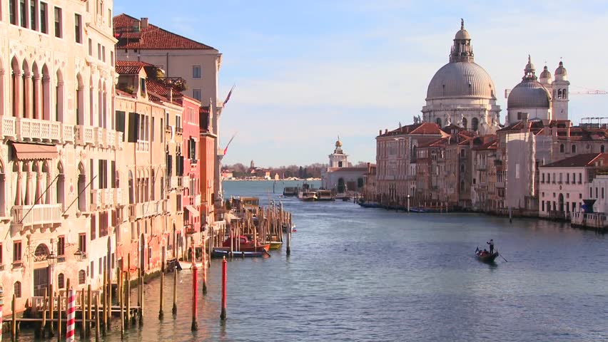 VENICE, ITALY-CIRCA 2011-A gondolier rows and we reveal a beautiful canal in Venice, Italy.
