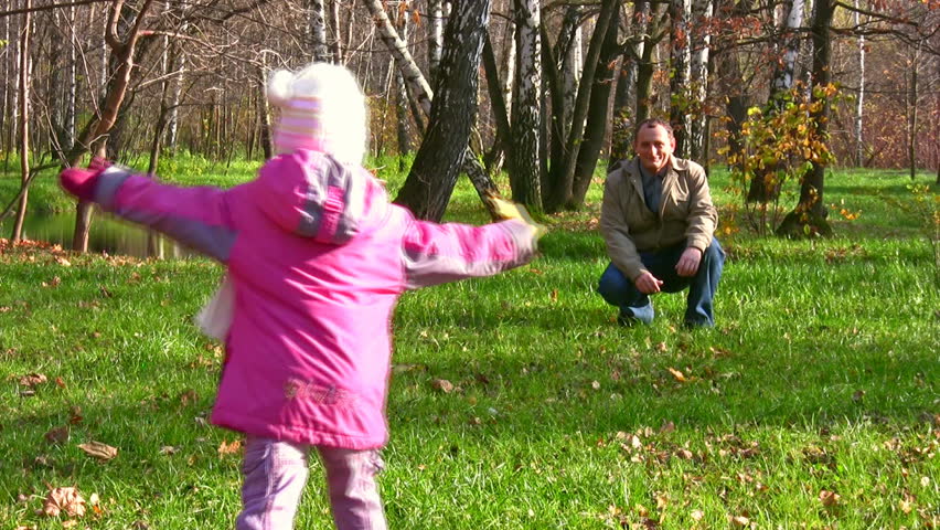 little girl run to senior in autumn park 