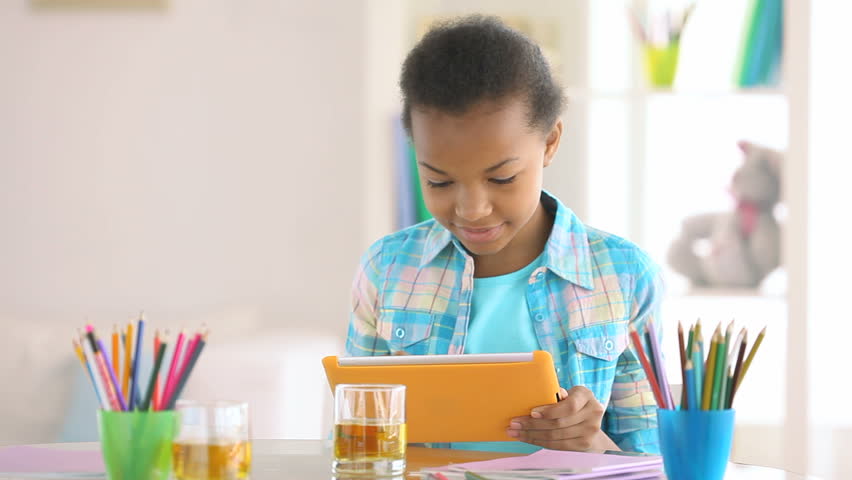 Smiling girl learning the basics of computer literacy