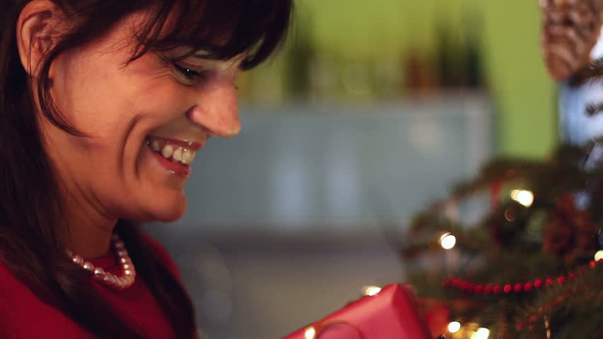 Young woman opening x-mass present