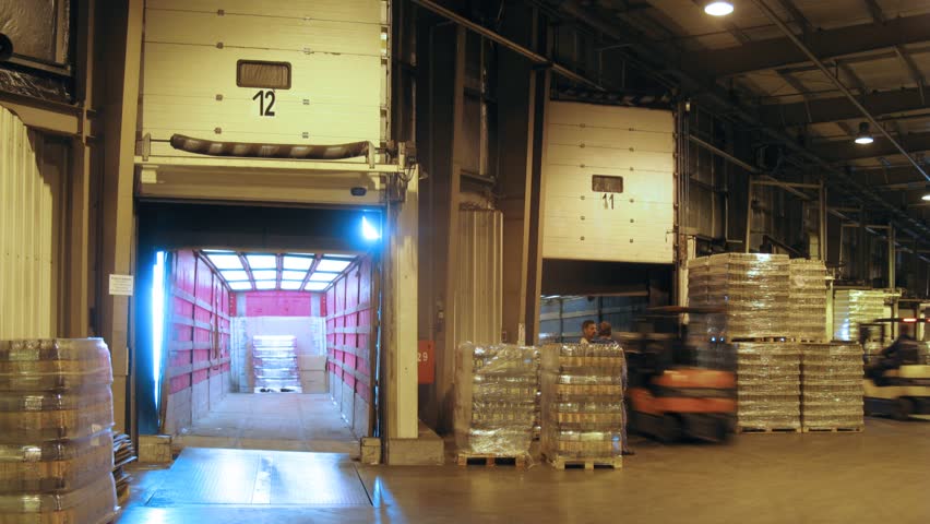 MOSCOW - MAY 31: (Timelapse View) Workers load container with quass in lorry at nonalcoholic plant Ochakovo, on May 31, 2012 in Moscow, Russia