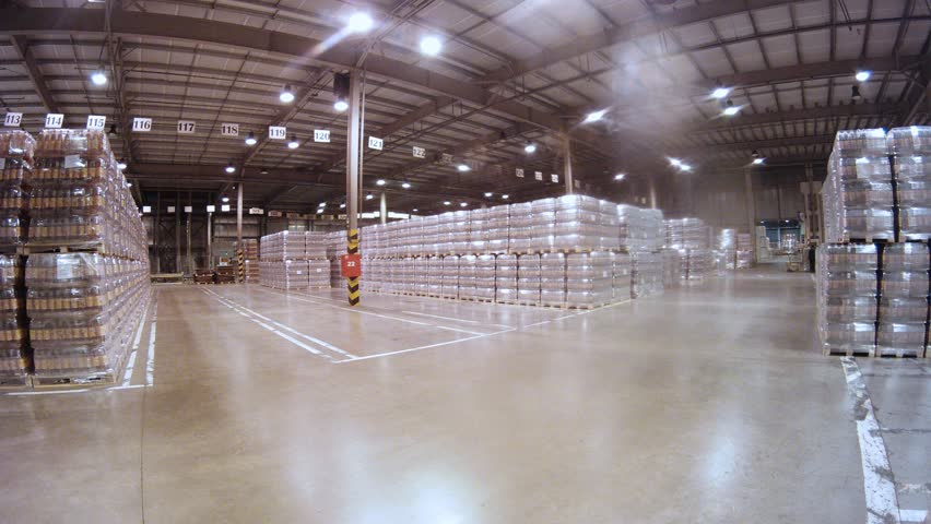 Loader transports containers with kvass in warehouse of plant of low alcohol drinks, time lapse