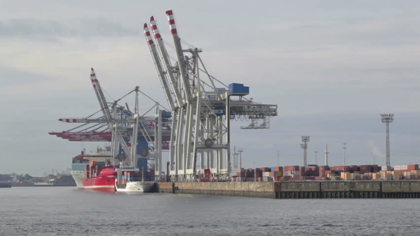 Unloading of the cargo ship at the Hamburg port on the Elbe river.