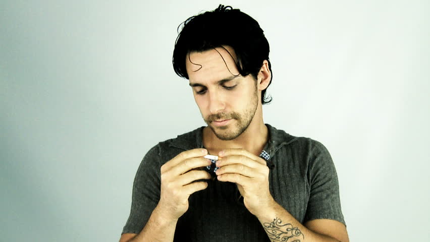Young handsome man stop smoking breaking cigarette