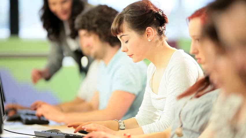 Group of multi ethnic male and female students focus on university project instruction Caucasian female teacher in IT information hub
