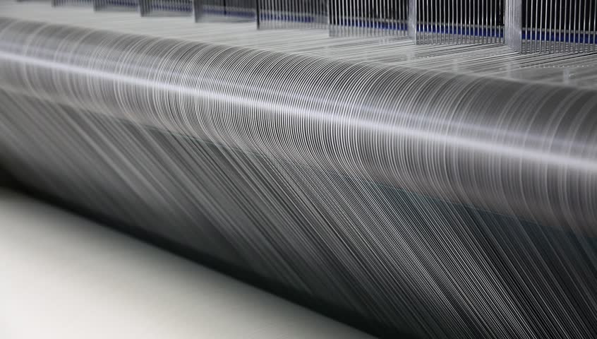 spinning machine collectes cotton threads in a cloth factory
