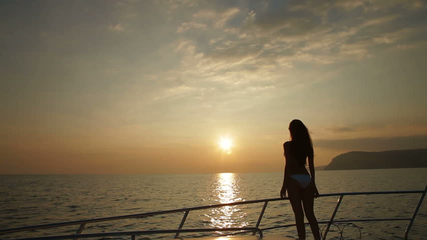 Bikini Female Silhouette on Yacht at Sunset