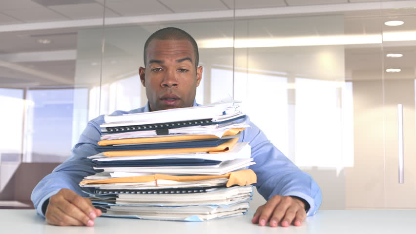 Frustrated businessman at work overwhelmed with work