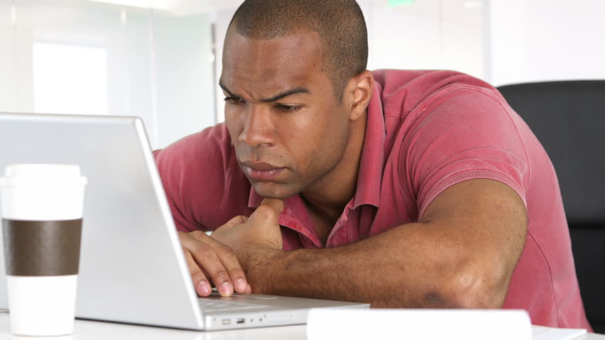 Serious man with laptop working