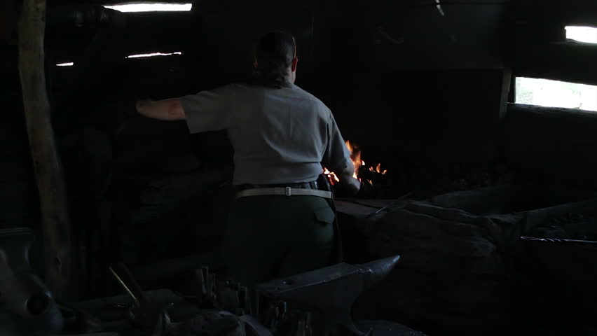 ROANOKE, USA - OCTOBER 27: A local park ranger demonstrates old blacksmithing techniques at a mill in the Blue Ridge Mountains, Virginia, USA.